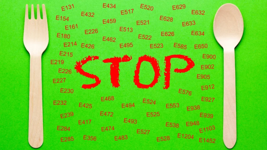 Green background with E numbers and the word “STOP” in red